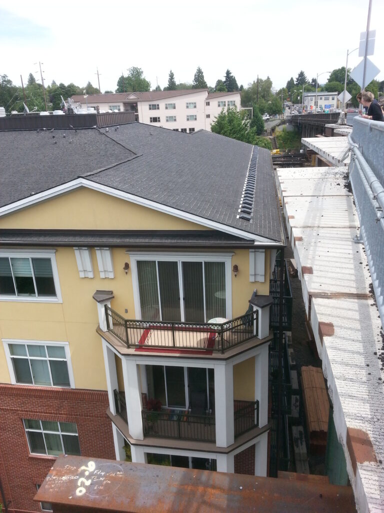 It’s been difficult to wedge a project this big into a quiet neighborhood like Sellwood, but the crews have done an amazing job.  This picture of the bridge and the condominiums on the north side shows just how careful they’re being.