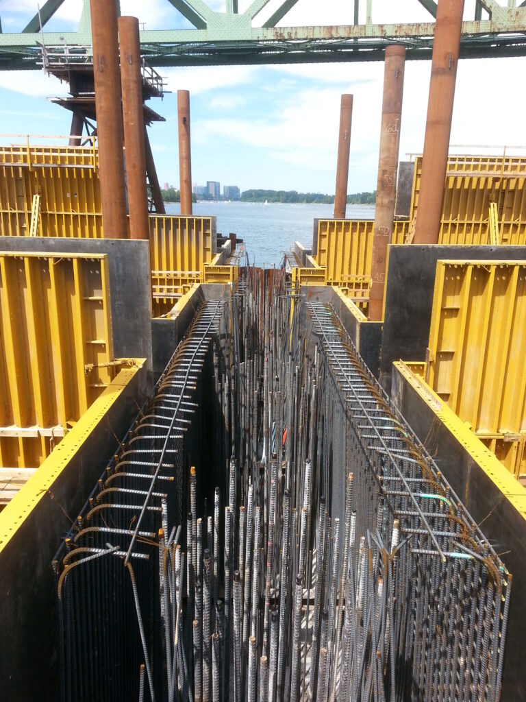 The steel arches will touch down on concrete supports at two points in the water.  This is a view into the box where the concrete bases will be cast, showing the massive amounts of rebar needed to make the concrete structurally sound.